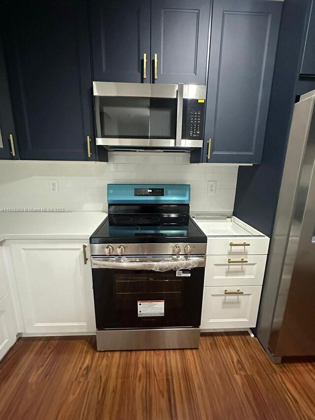 11281 NW 42nd Ter Unit 0, Doral, FL 33178 - kitchen featuring appliances with stainless steel finishes, light countertops, backsplash, and dark wood-type flooring