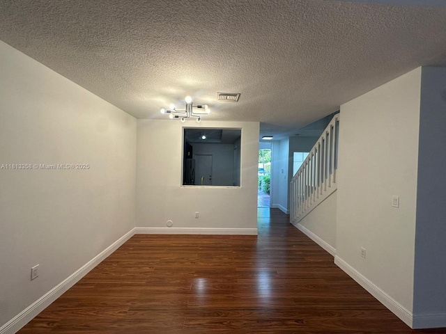 11281 NW 42nd Ter Unit 0, Doral, FL 33178 - empty room featuring dark wood-type flooring, a chandelier, baseboards, and a textured ceiling