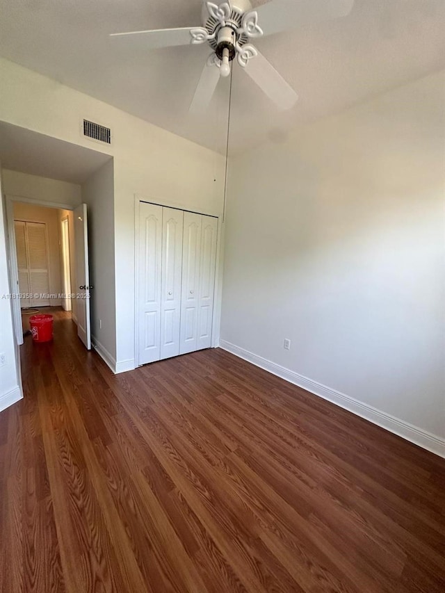 11281 NW 42nd Ter Unit 0, Doral, FL 33178 - unfurnished bedroom with baseboards, dark wood-style floors, a closet, and a ceiling fan