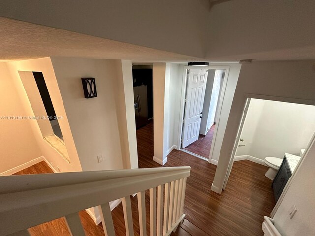 11281 NW 42nd Ter Unit 0, Doral, FL 33178 - hallway featuring baseboards and dark wood-style flooring