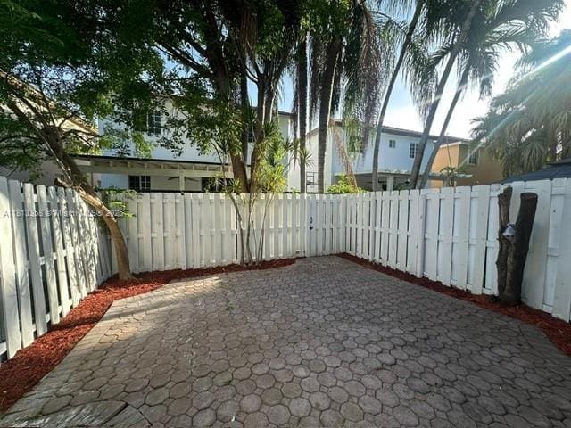 11281 NW 42nd Ter Unit 0, Doral, FL 33178 - fenced backyard with a patio area