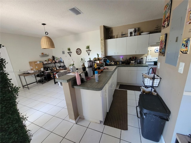 14730 SW 142nd St, Miami, FL 33196 - kitchen featuring tile countertops, range, white cabinetry, a sink, and electric panel