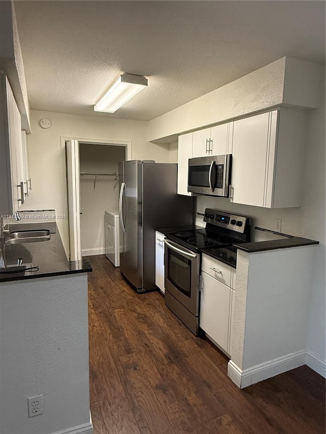 833 Riverside Dr Unit 834, Coral Springs, FL 33071 - kitchen featuring appliances with stainless steel finishes, dark countertops, dark wood-style floors, white cabinetry, and a sink