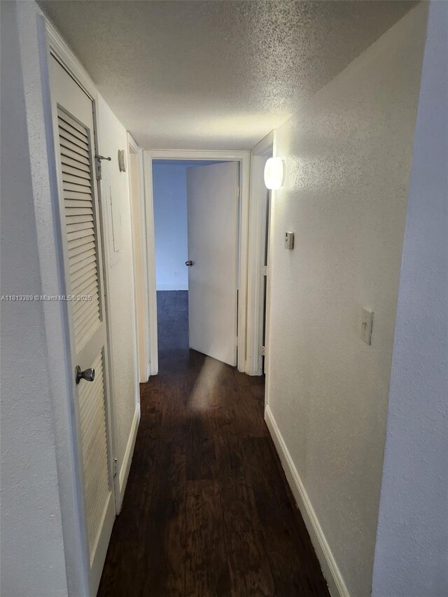 833 Riverside Dr Unit 834, Coral Springs, FL 33071 - hallway with wood finished floors, baseboards, a textured wall, and a textured ceiling