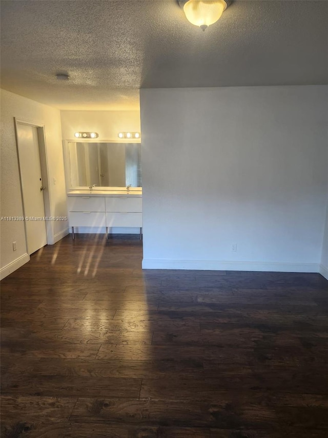 833 Riverside Dr Unit 834, Coral Springs, FL 33071 - empty room with dark wood finished floors, a textured ceiling, and baseboards