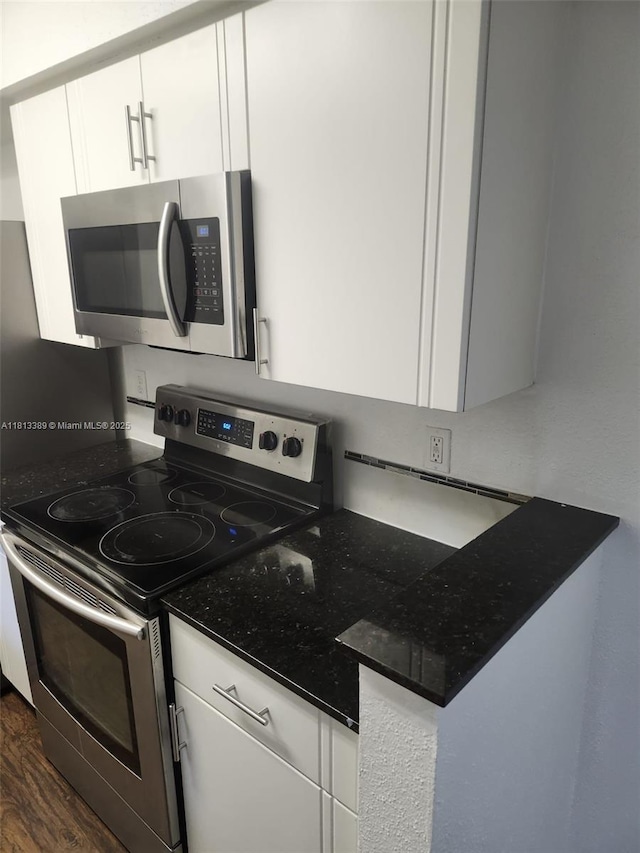 833 Riverside Dr Unit 834, Coral Springs, FL 33071 - kitchen featuring appliances with stainless steel finishes, white cabinetry, dark wood-style floors, and dark stone counters