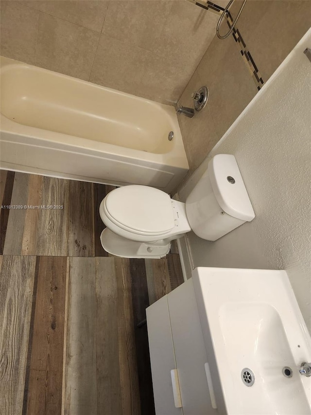833 Riverside Dr Unit 834, Coral Springs, FL 33071 - full bath with toilet, a sink, a tub to relax in, and wood finished floors