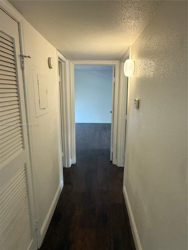 833 Riverside Dr Unit 834, Coral Springs, FL 33071 - corridor featuring a textured ceiling, baseboards, and dark wood-style flooring