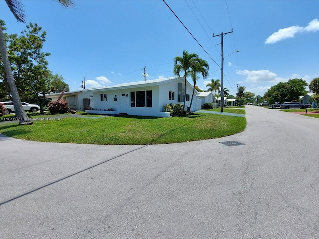 4579 NW 16th Way, Tamarac, FL 33309 - view of front facade featuring a front lawn and stucco siding