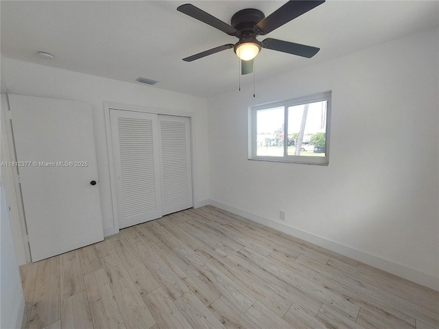4579 NW 16th Way, Tamarac, FL 33309 - unfurnished bedroom featuring light wood-style floors, a closet, baseboards, and a ceiling fan