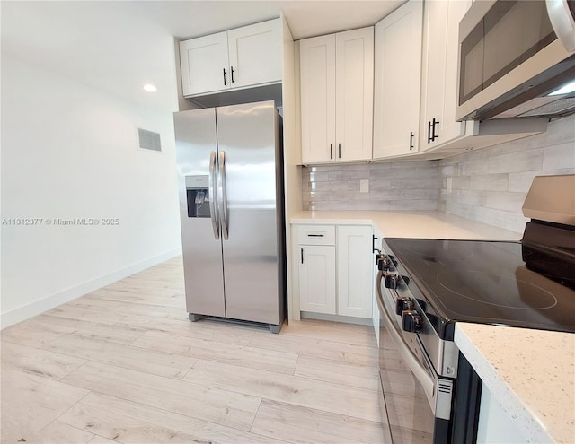 4579 NW 16th Way, Tamarac, FL 33309 - kitchen with appliances with stainless steel finishes, light countertops, tasteful backsplash, white cabinets, and recessed lighting