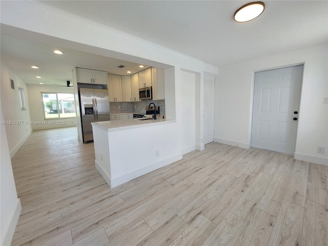 4579 NW 16th Way, Tamarac, FL 33309 - kitchen with appliances with stainless steel finishes, light wood-type flooring, light countertops, backsplash, and recessed lighting