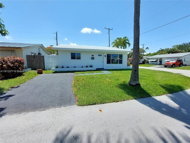 4579 NW 16th Way, Tamarac, FL 33309 - ranch-style home with asphalt driveway and stucco siding