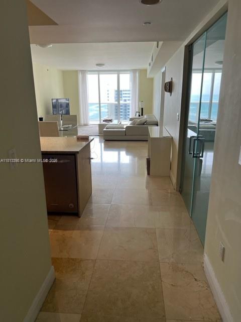 1830 S Ocean Dr Unit 2103, Hallandale Beach, FL 33009 - corridor with a wall of windows and baseboards