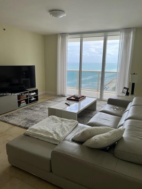 1830 S Ocean Dr Unit 2103, Hallandale Beach, FL 33009 - living room featuring a water view and a wall of windows