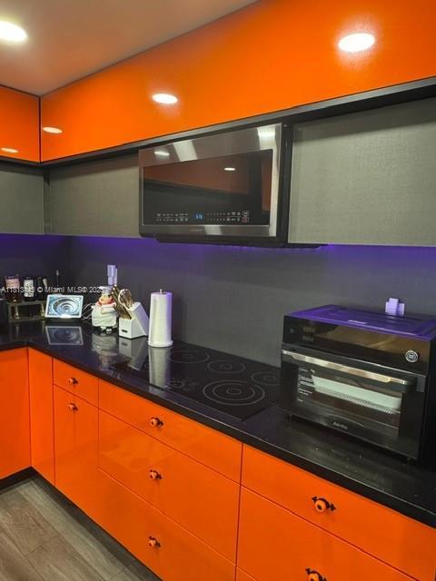 4550 NW 9th St Unit 520E, Miami, FL 33126 - kitchen featuring wood finished floors and dark countertops