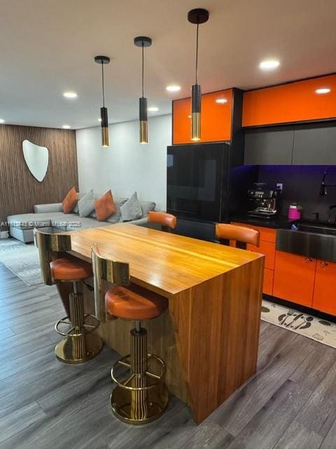 4550 NW 9th St Unit 520E, Miami, FL 33126 - bar area featuring dark wood-type flooring, a sink, recessed lighting, and pendant lighting