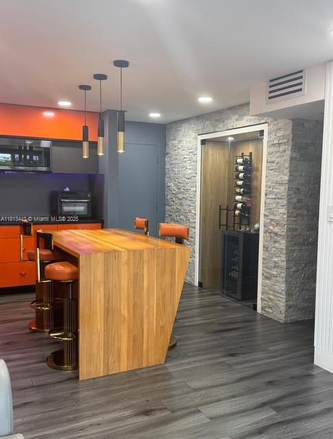 4550 NW 9th St Unit 520E, Miami, FL 33126 - indoor dry bar featuring dark wood-style floors, hanging light fixtures, and recessed lighting
