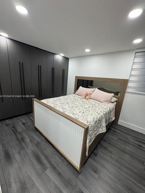 4550 NW 9th St Unit 520E, Miami, FL 33126 - bedroom with dark wood finished floors, recessed lighting, and baseboards