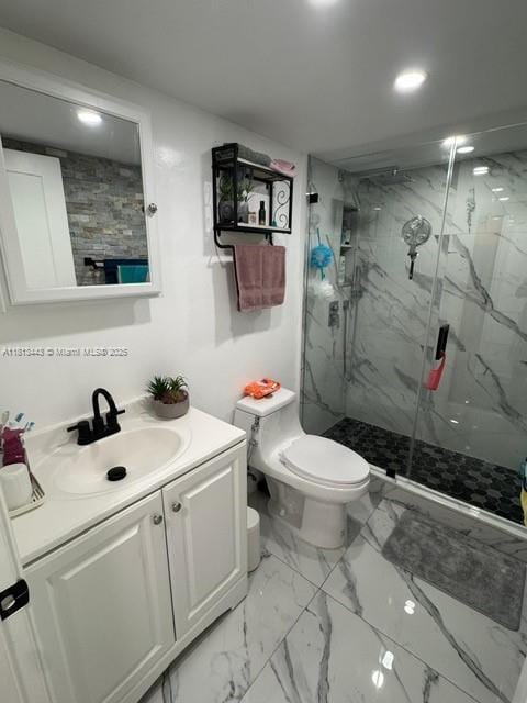 4550 NW 9th St Unit 520E, Miami, FL 33126 - bathroom with toilet, a marble finish shower, vanity, recessed lighting, and marble look tiles