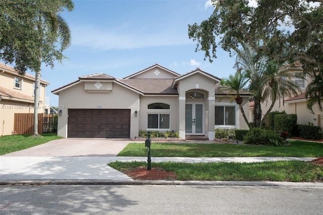 16404 Diamond Pl, Weston, FL 33331 - view of front of home featuring french doors, a garage, a tile roof, driveway, and stucco siding