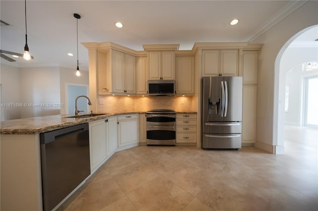 16404 Diamond Pl, Weston, FL 33331 - kitchen with stainless steel appliances, cream cabinetry, a sink, arched walkways, and crown molding
