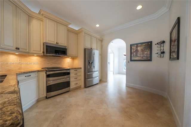 16404 Diamond Pl, Weston, FL 33331 - kitchen featuring stainless steel appliances, cream cabinetry, arched walkways, crown molding, and tasteful backsplash
