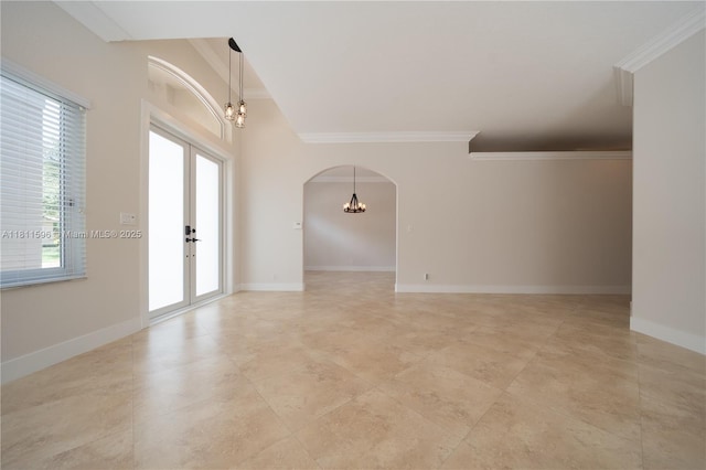 16404 Diamond Pl, Weston, FL 33331 - unfurnished room with a chandelier, arched walkways, crown molding, french doors, and baseboards