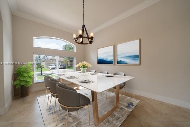 16404 Diamond Pl, Weston, FL 33331 - dining room featuring crown molding, a chandelier, baseboards, and light tile patterned floors
