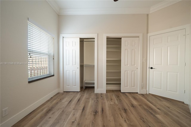 16404 Diamond Pl, Weston, FL 33331 - unfurnished bedroom with crown molding, multiple closets, baseboards, and wood finished floors