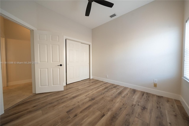 16404 Diamond Pl, Weston, FL 33331 - unfurnished bedroom with baseboards, wood finished floors, a closet, and ceiling fan