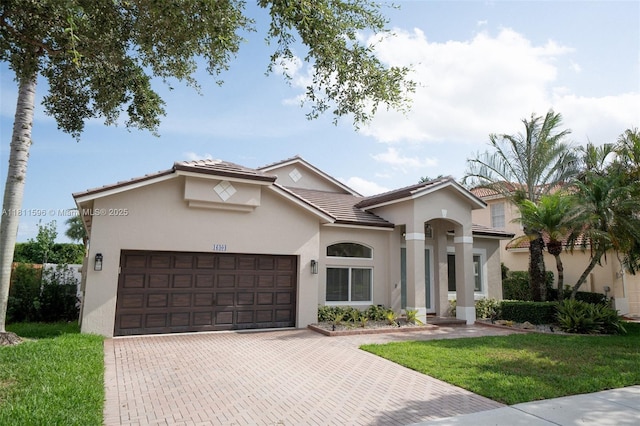 16404 Diamond Pl, Weston, FL 33331 - mediterranean / spanish house with an attached garage, stucco siding, decorative driveway, a front yard, and a tile roof