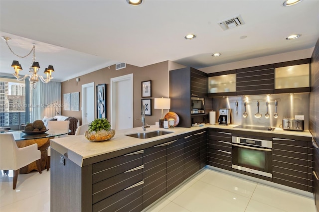200 Biscayne Boulevard Way Unit 3904, Miami, FL 33131 - kitchen featuring stainless steel appliances, light tile patterned flooring, a peninsula, a sink, and light countertops