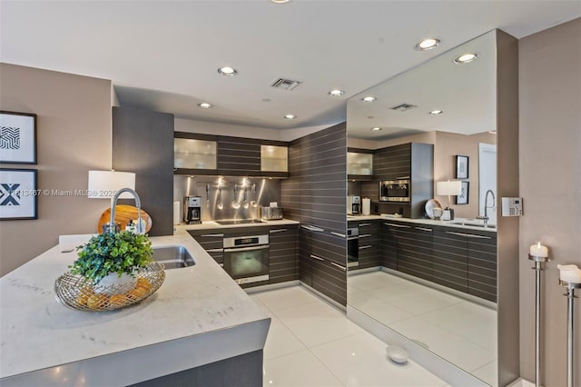 200 Biscayne Boulevard Way Unit 3904, Miami, FL 33131 - kitchen featuring stainless steel oven, modern cabinets, black electric stovetop, a sink, and light tile patterned floors