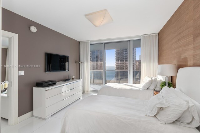 200 Biscayne Boulevard Way Unit 3904, Miami, FL 33131 - bedroom with access to outside, baseboards, an accent wall, and light tile patterned floors