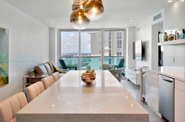 4001 S Ocean Dr Unit 14H, Hollywood, FL 33019 - dining area with expansive windows, wine cooler, and recessed lighting