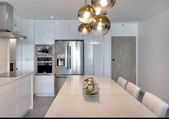 4001 S Ocean Dr Unit 14H, Hollywood, FL 33019 - kitchen featuring appliances with stainless steel finishes, wall chimney exhaust hood, modern cabinets, and white cabinetry