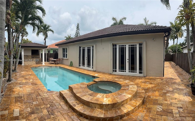 8792 NW 167th St, Miami Lakes, FL 33018 - view of pool with french doors, a patio area, a fenced backyard, and a pool with connected hot tub