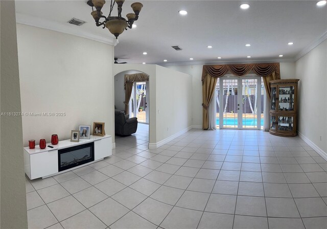 8792 NW 167th St, Miami Lakes, FL 33018 - spare room featuring arched walkways, ornamental molding, a chandelier, recessed lighting, and french doors
