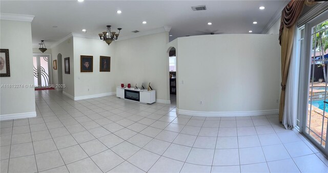 8792 NW 167th St, Miami Lakes, FL 33018 - empty room featuring arched walkways, crown molding, a chandelier, recessed lighting, and light tile patterned floors