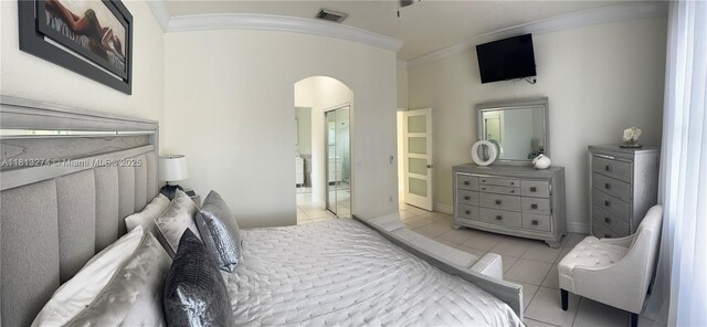 8792 NW 167th St, Miami Lakes, FL 33018 - bedroom with arched walkways, crown molding, tile patterned flooring, and baseboards