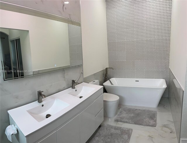 8792 NW 167th St, Miami Lakes, FL 33018 - full bathroom featuring tile walls, a freestanding tub, double vanity, marble look tiles, and toilet