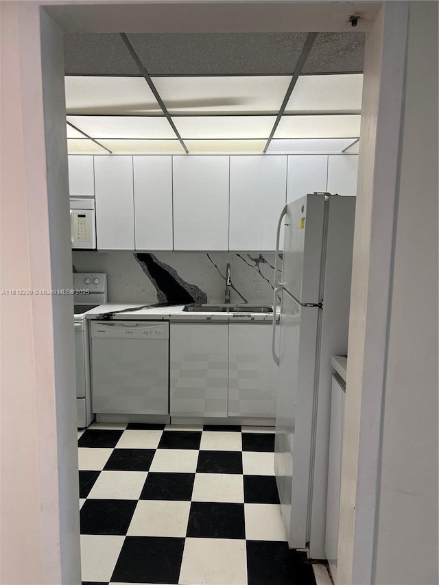 3475 S Ocean Blvd Unit 1130, Palm Beach, FL 33480 - kitchen featuring white appliances, white cabinets, a sink, and modern cabinets