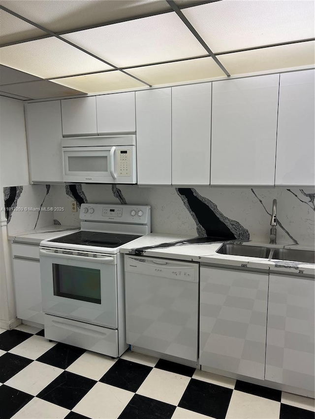 3475 S Ocean Blvd Unit 1130, Palm Beach, FL 33480 - kitchen with white appliances, a sink, light flooring, and white cabinets