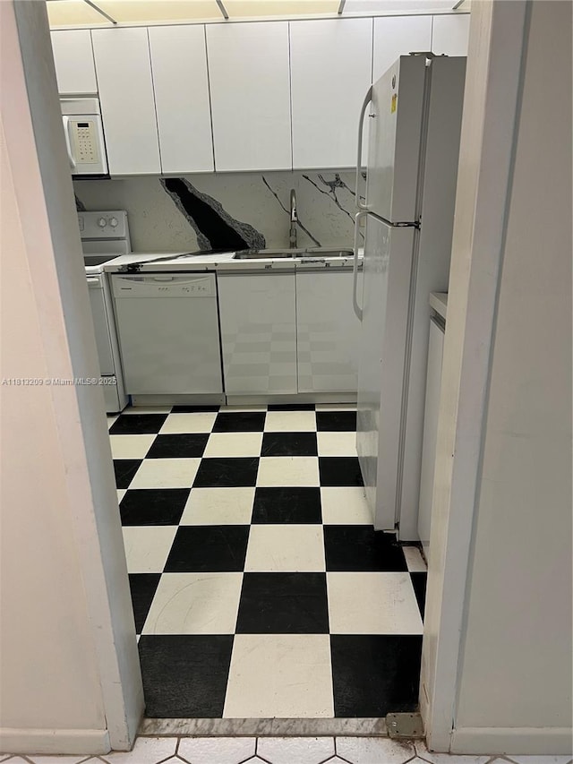 3475 S Ocean Blvd Unit 1130, Palm Beach, FL 33480 - kitchen with white appliances, a sink, white cabinetry, modern cabinets, and light flooring
