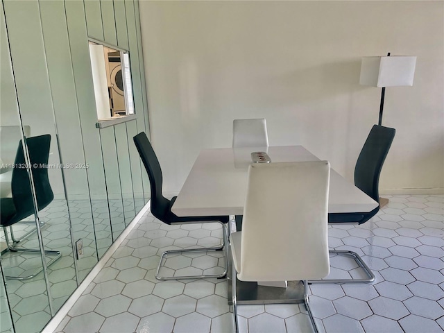 3475 S Ocean Blvd Unit 1130, Palm Beach, FL 33480 - tiled dining space featuring stacked washer / drying machine
