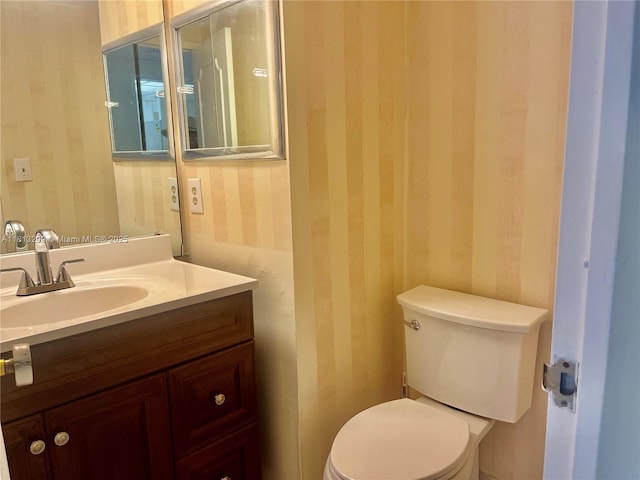 3475 S Ocean Blvd Unit 1130, Palm Beach, FL 33480 - half bathroom featuring wallpapered walls, vanity, and toilet