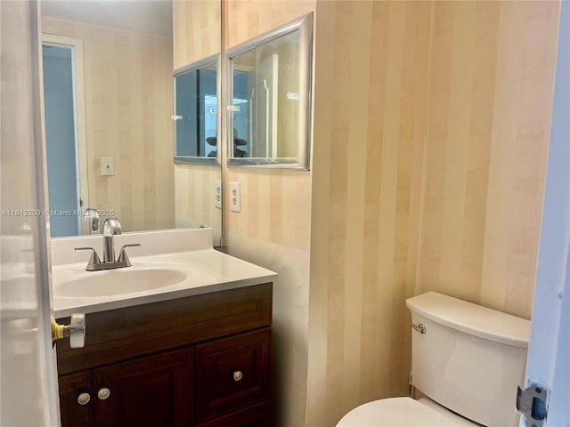 3475 S Ocean Blvd Unit 1130, Palm Beach, FL 33480 - half bath featuring wallpapered walls, toilet, and vanity