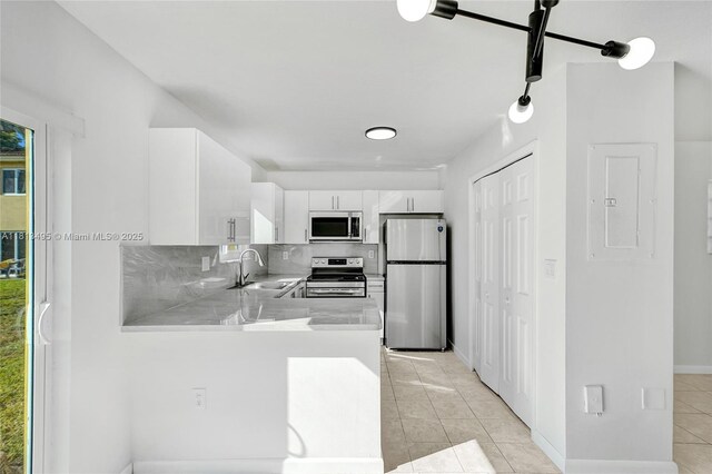 3398 NE 9th Dr Unit 104, Homestead, FL 33033 - kitchen featuring stainless steel appliances, a sink, light tile patterned floors, white cabinetry, and light countertops