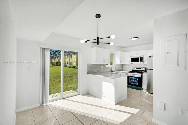 3398 NE 9th Dr Unit 104, Homestead, FL 33033 - kitchen with stainless steel appliances, light tile patterned flooring, a peninsula, and light countertops